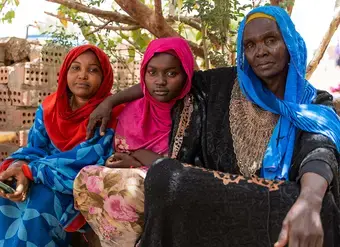 Aziza Ibrahim (right) is seen with with her daughters Amal (middle) and Eman (left). 