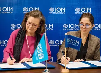 UN Women Deputy Executive Director Kirsi Madi (left) signs a new partnership with Catalina Devandas, IOM Representative of the Director General Office of Partnerships, Advocacy, and Communication.
