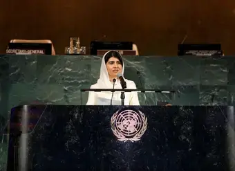 Malala Yousafzai speaks from a podium