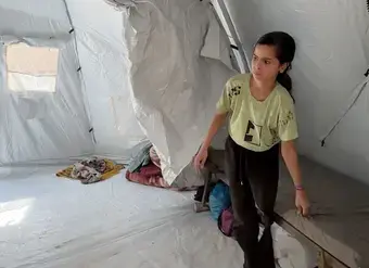 Young girl inside a tent. 