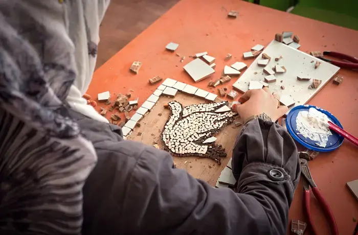 Alaa' is engaged as a cash-for-work beneficiary in UN Women's mosaic workshop in Za'atari camp. 
