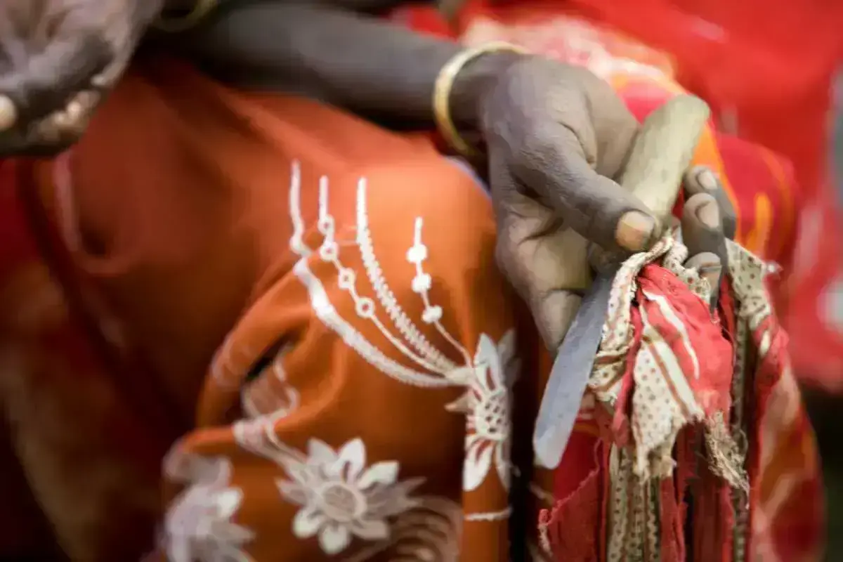Boko Mohammed, a former excisor (a practitioner who performs female genital mutilation), holds the tool she used to perform the procedure at a community meeting in Kabele Village, inAmibara District, Afar Region.