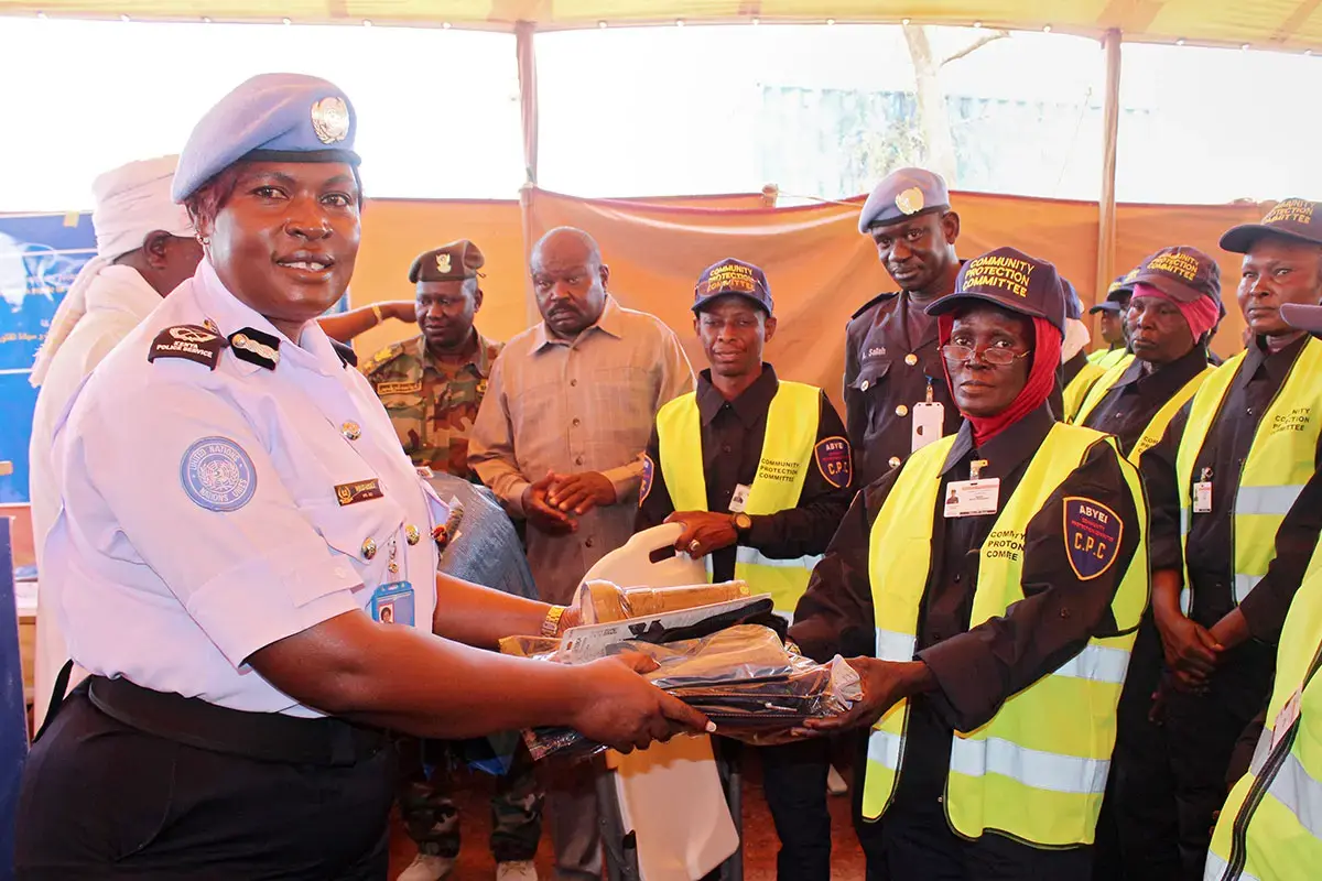 Police Commissioner Violet Lusala distributes uniforms to one of the newly formed CPCs in Abyei in April 2025. Photo: UNISFA