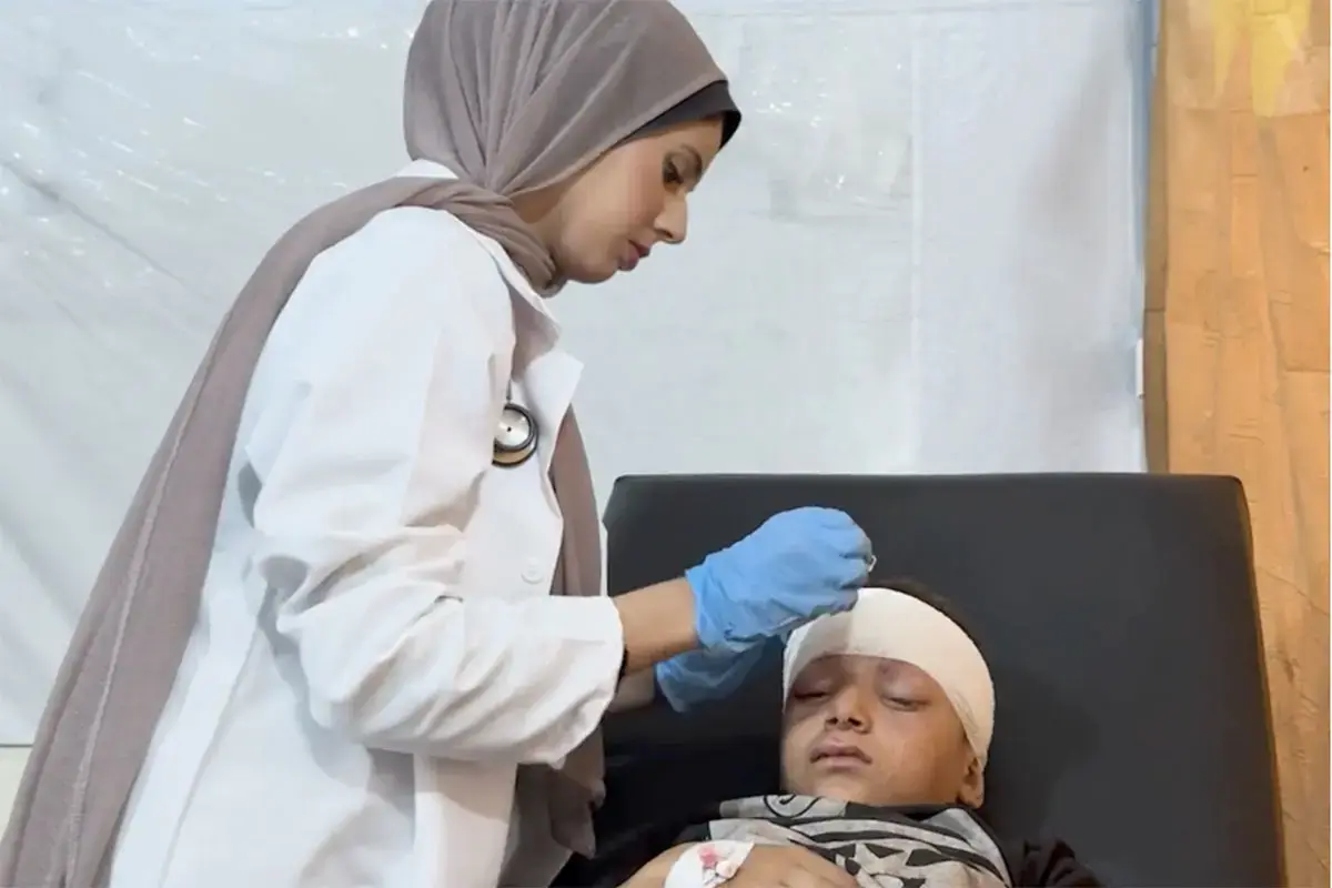 A female medical student treats an injured child in a medical facility in Gaza.