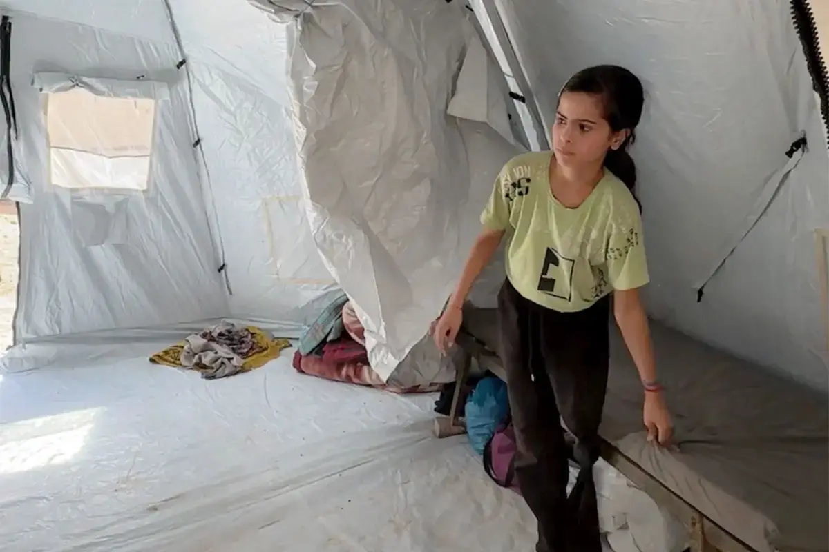 Young girl inside a tent. 