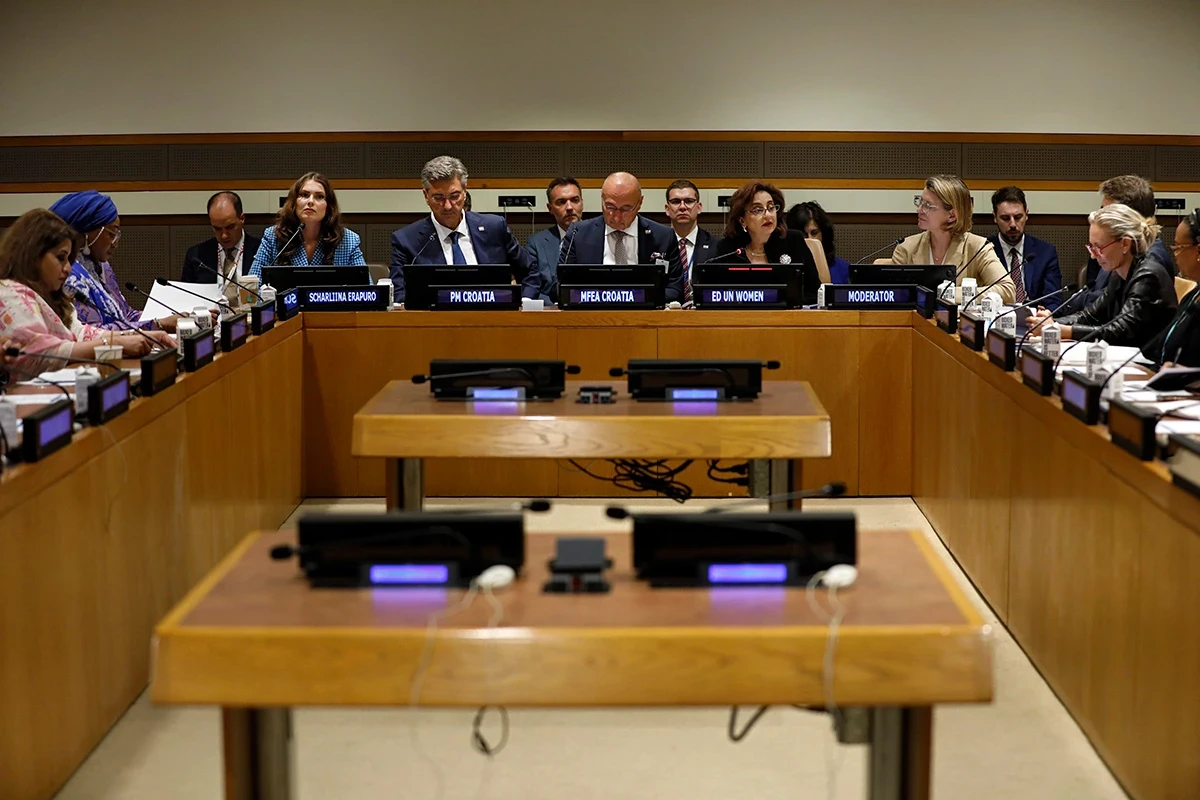 UN Women Executive Director Sima Bahous delivers opening remarks at a ministerial roundtable, with officials and participants seated around the conference table.