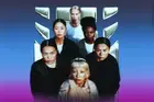 Six women standing closely together against a blue-to-purple gradient background, facing the camera with serious expressions. They are positioned in two rows, with a metallic UN Women logo displayed behind them. The women have diverse appearances and wear dark and neutral-toned clothing, creating a strong, unified group portrait.