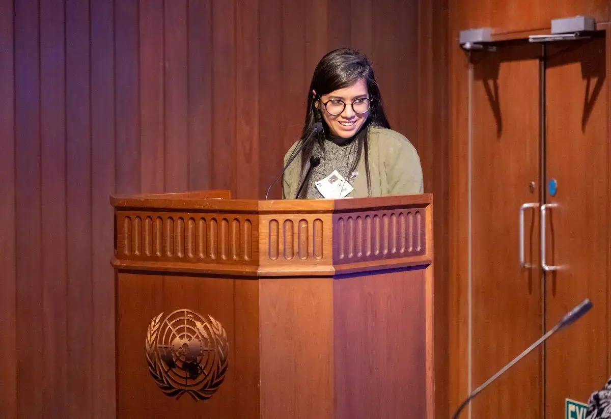 Sushmita S. Preetha speaks at a podium with the United Nations logo