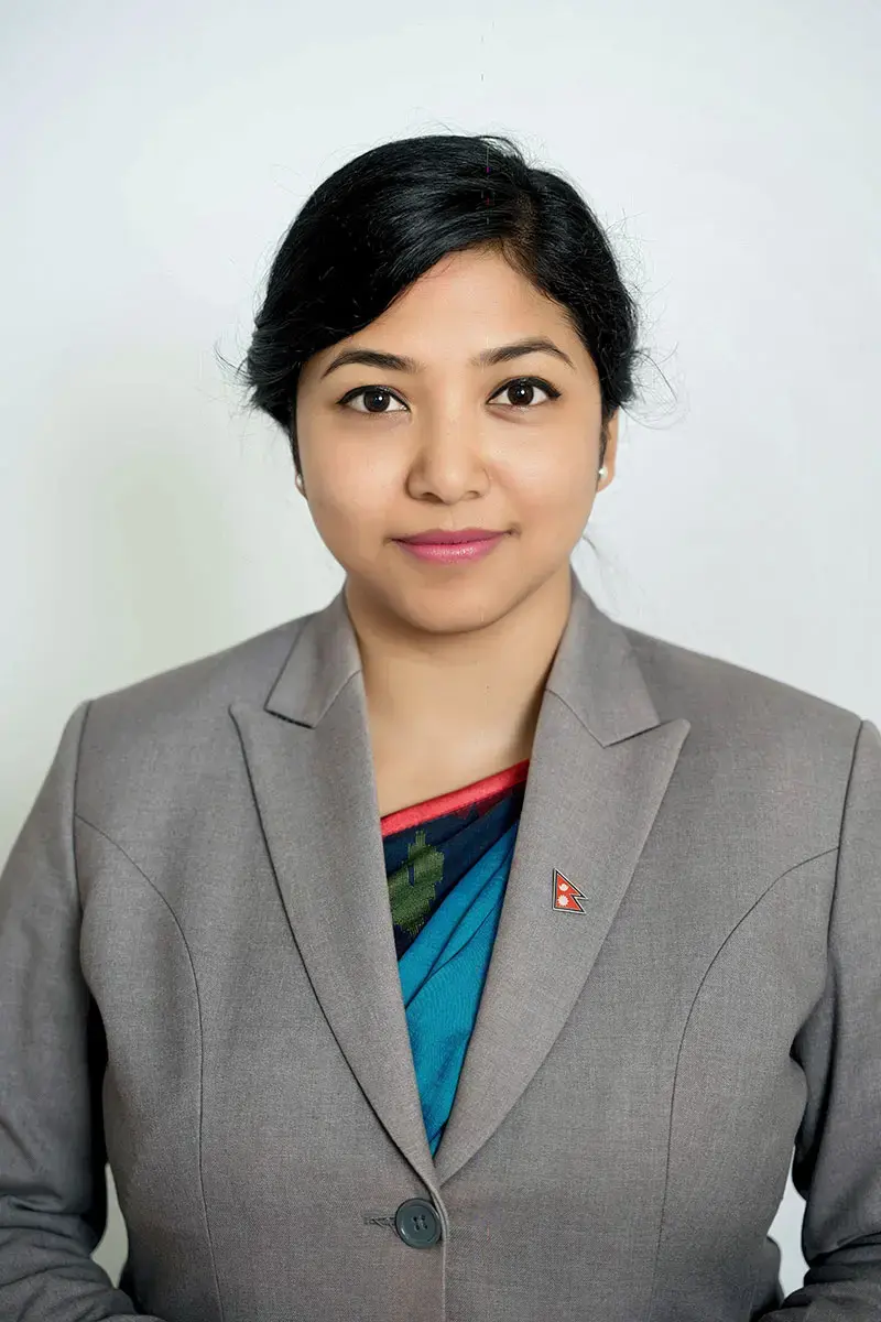 A portrait of a woman against a plain background.