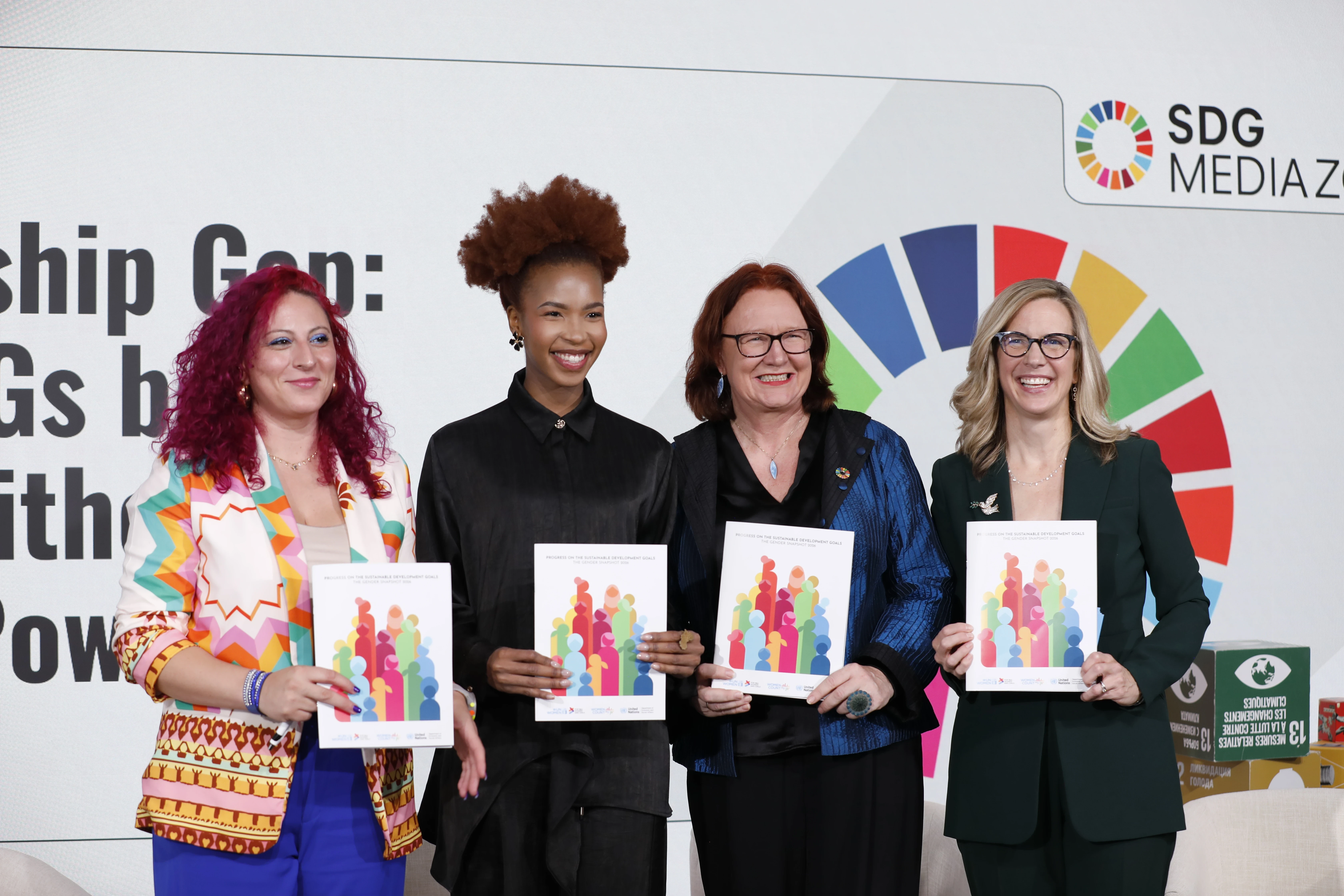 Four women pose holding copies of the 2026 Gender Snapshot report